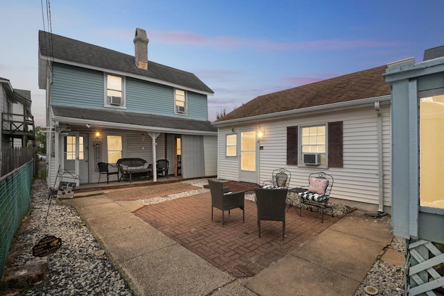 126 W Andrews Ave, Wildwood, NJ 08260 - back of property at dusk with a patio area, a chimney, and cooling unit