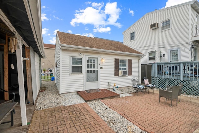 126 W Andrews Ave, Wildwood, NJ 08260 - rear view of property with a patio area, a deck, a wall mounted air conditioner, and a shingled roof