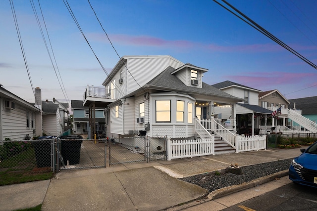 126 W Andrews Ave, Wildwood, NJ 08260 - view of front facade with a gate, covered porch, a fenced front yard, and roof with shingles