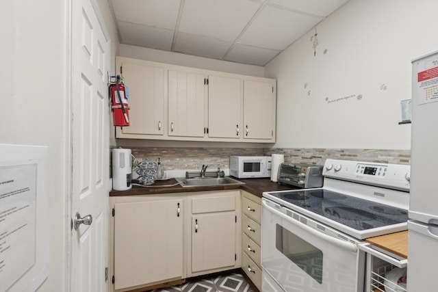 126 W Andrews Ave, Wildwood, NJ 08260 - kitchen with white appliances, a drop ceiling, tasteful backsplash, and wooden counters