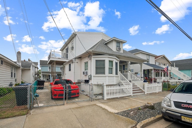 126 W Andrews Ave, Wildwood, NJ 08260 - view of front of home featuring a gate, a porch, a fenced front yard, and a residential view