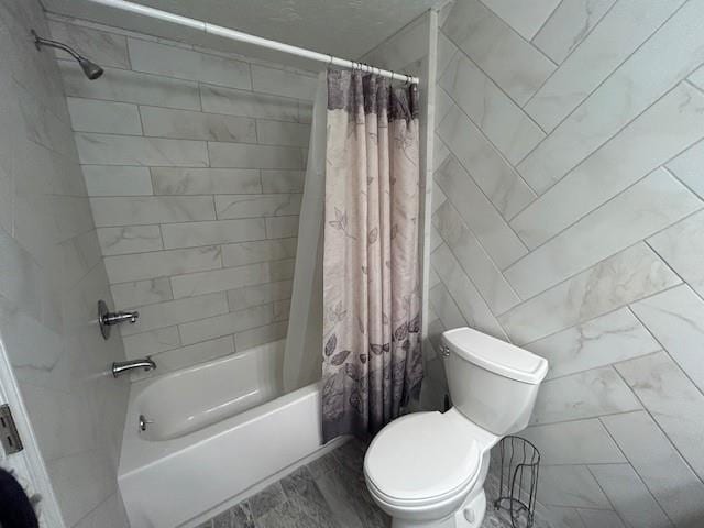 bathroom featuring tile walls, marble finish floor, shower / bathtub combination with curtain, and toilet