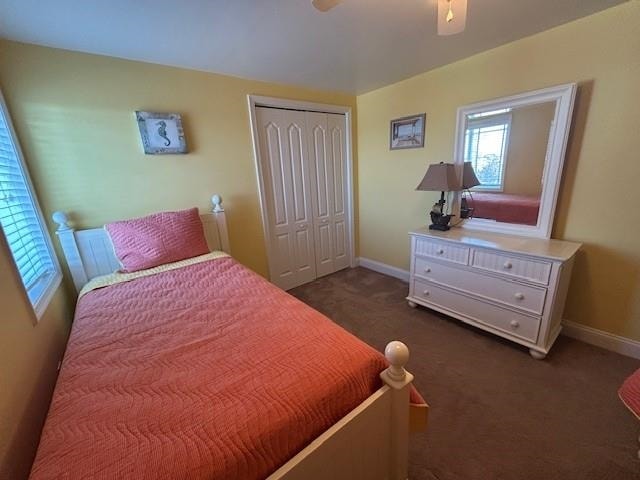 carpeted bedroom featuring a closet, ceiling fan, and baseboards