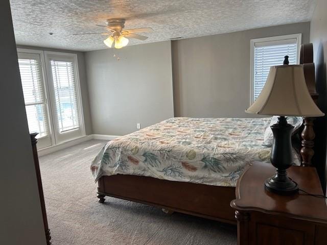 bedroom with carpet floors, ceiling fan, a textured ceiling, and baseboards