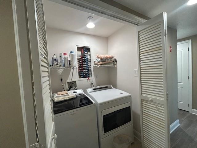 laundry room with laundry area, baseboards, washing machine and clothes dryer, and wood finished floors