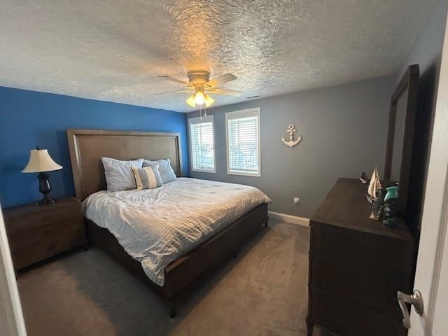 carpeted bedroom with ceiling fan, baseboards, and a textured ceiling