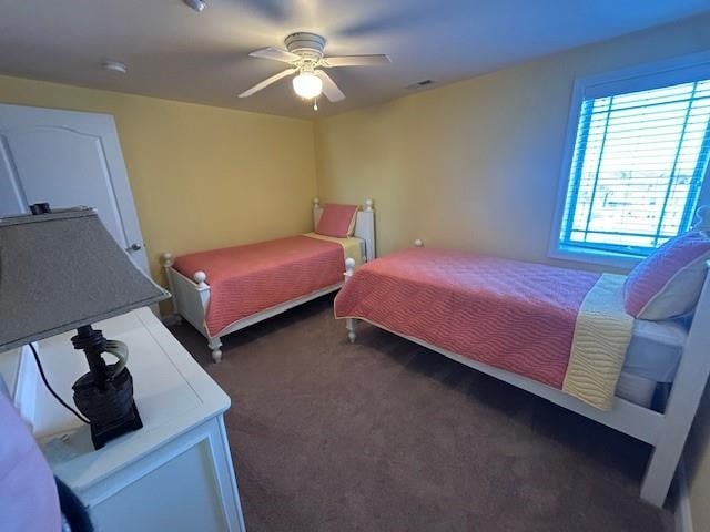 bedroom featuring ceiling fan, carpet, and visible vents