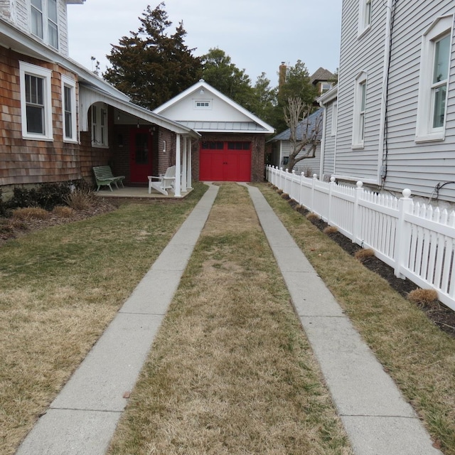 view of yard with driveway and fence