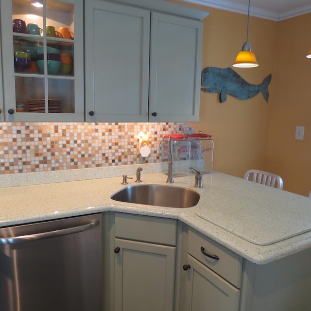 kitchen featuring decorative light fixtures, backsplash, ornamental molding, a sink, and dishwasher