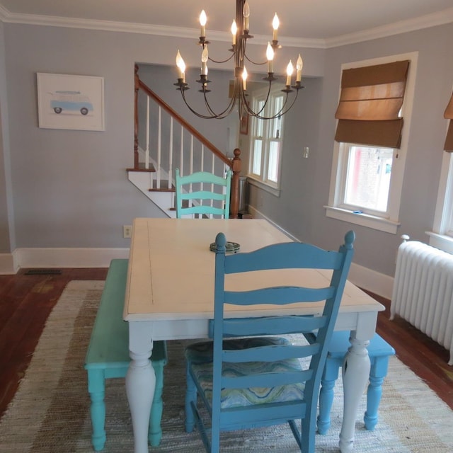 dining area featuring baseboards, radiator heating unit, wood finished floors, and crown molding