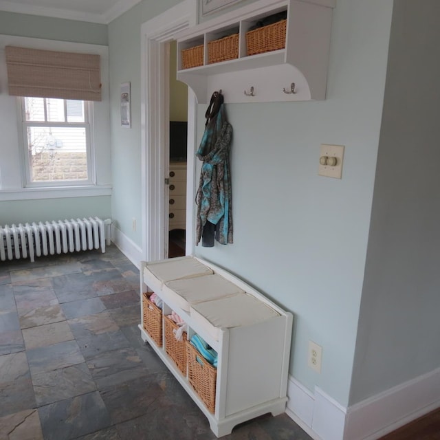 mudroom with stone finish floor, radiator heating unit, and baseboards