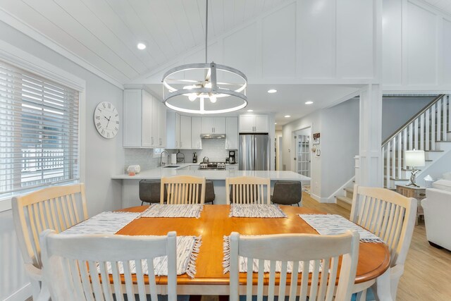 108 27th St, Avalon, NJ 08202 - dining area with stairway, light wood-style floors, vaulted ceiling, a chandelier, and ornamental molding