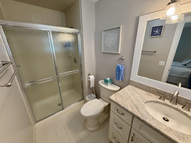 full bathroom featuring a stall shower, tile patterned flooring, vanity, and toilet