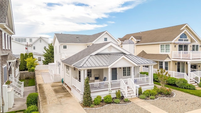 108 27th St, Avalon, NJ 08202 - view of front of house with a porch, a shingled roof, a standing seam roof, metal roof, and stairway