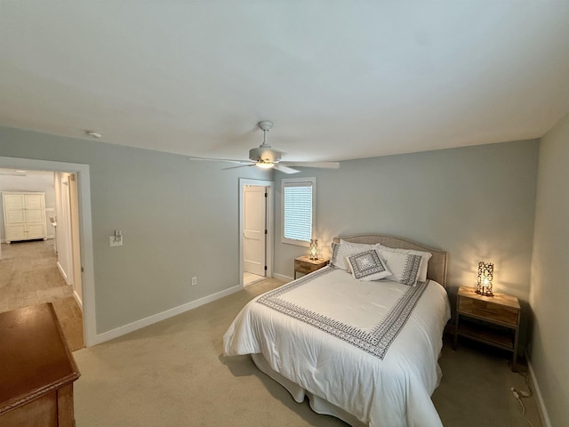 bedroom with baseboards, a ceiling fan, and light colored carpet
