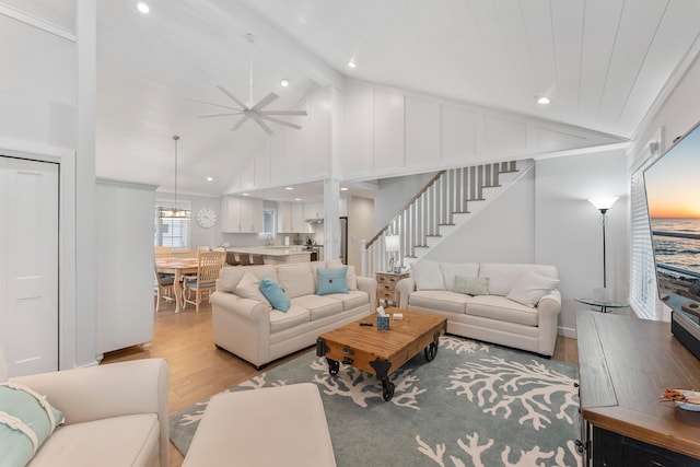 108 27th St, Avalon, NJ 08202 - living area featuring light wood finished floors, stairway, ceiling fan, beam ceiling, and high vaulted ceiling