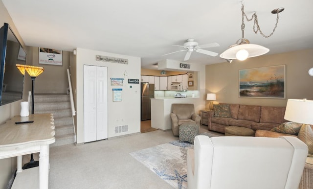 309 E Surf Ave Unit 12, North Wildwood, NJ 08260 - living area featuring light carpet, a ceiling fan, and stairs