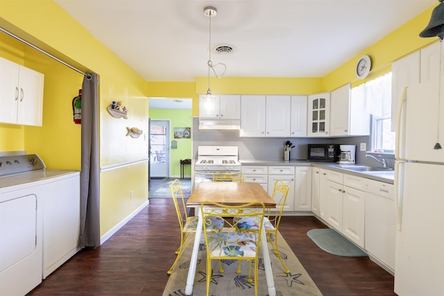 kitchen with white appliances, sink, decorative light fixtures, separate washer and dryer, and white cabinets