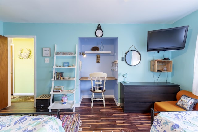 bedroom with dark hardwood / wood-style flooring