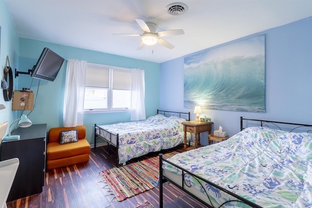 bedroom with ceiling fan and dark hardwood / wood-style flooring