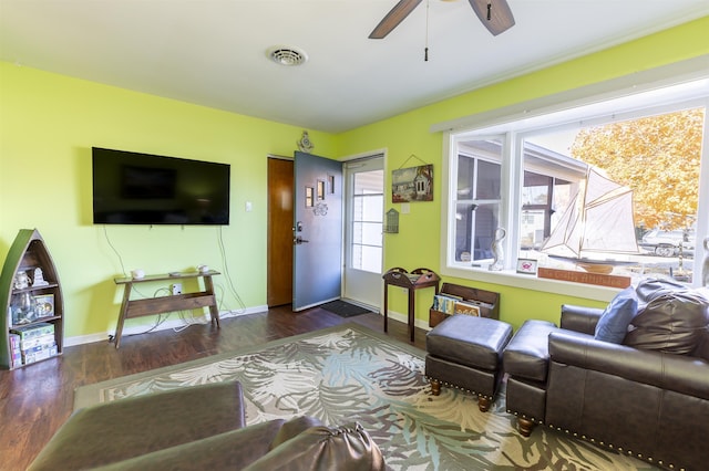 living room with ceiling fan and dark wood-type flooring