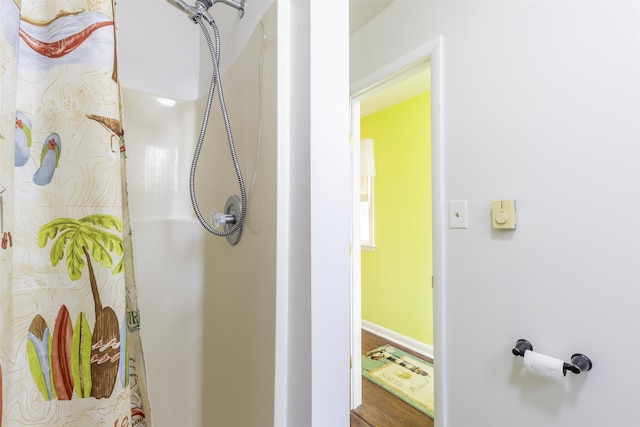 bathroom with wood-type flooring and walk in shower