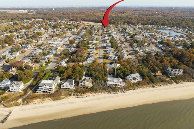 bird's eye view featuring a water view and a beach view