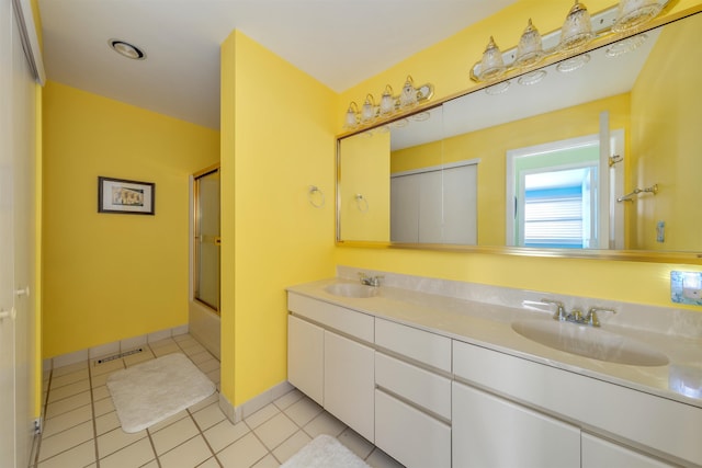 902 Ocean Dr Unit 306, Lower Township, NJ 08204 - bathroom featuring combined bath / shower with glass door, double vanity, a sink, and tile patterned flooring