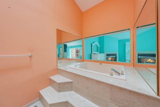 902 Ocean Dr Unit 306, Lower Township, NJ 08204 - full bath featuring a garden tub, high vaulted ceiling, and a glass covered fireplace