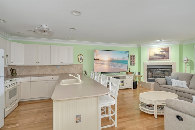 902 Ocean Dr Unit 306, Lower Township, NJ 08204 - kitchen featuring crown molding, white range with electric cooktop, a peninsula, a sink, and a breakfast bar area