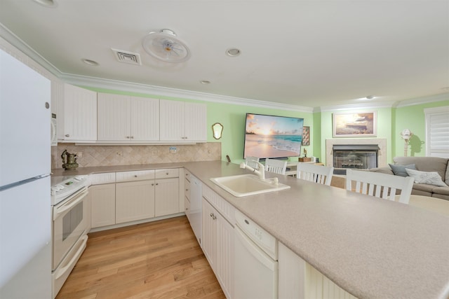 902 Ocean Dr Unit 306, Lower Township, NJ 08204 - kitchen with visible vents, a sink, white appliances, crown molding, and a glass covered fireplace