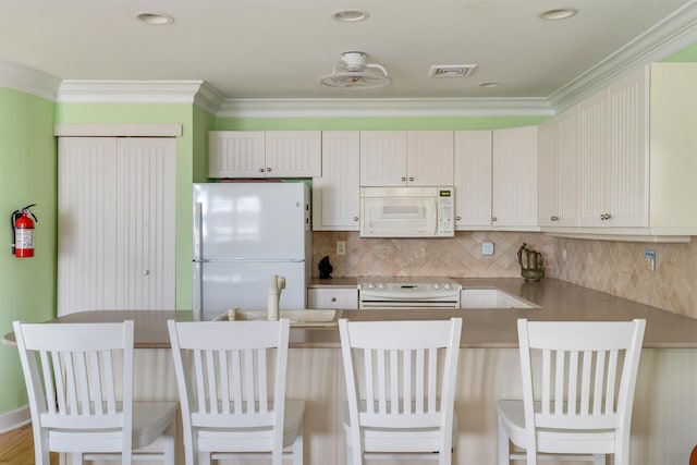 902 Ocean Dr Unit 306, Lower Township, NJ 08204 - kitchen with white appliances, visible vents, backsplash, and a peninsula