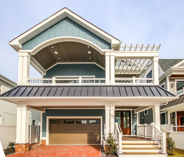 view of front of property featuring a porch, a balcony, and a garage