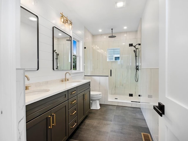 bathroom featuring vanity, an enclosed shower, and toilet