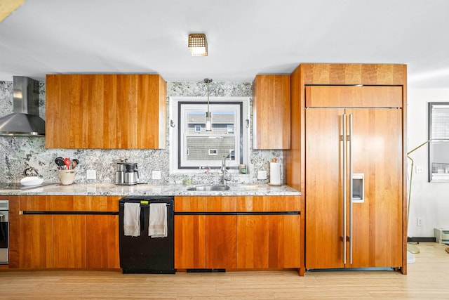 94 Delaware Ave, Fortescue, NJ 08321 - kitchen with dishwasher, brown cabinetry, light stone counters, wall chimney exhaust hood, and paneled refrigerator