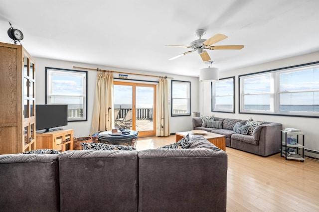 living room with ceiling fan and light hardwood / wood-style flooring