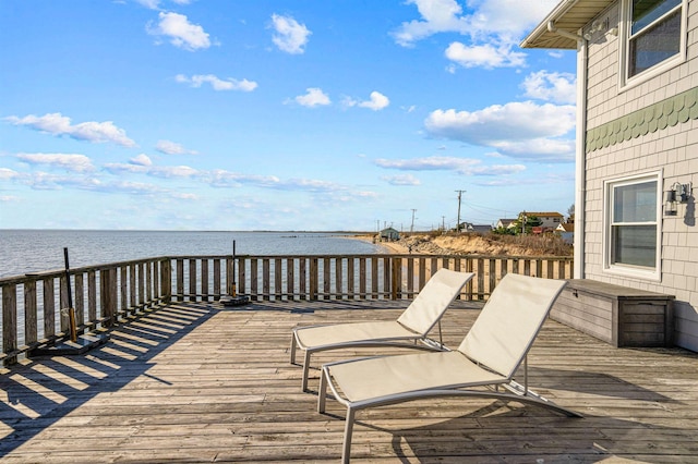 wooden terrace featuring a water view