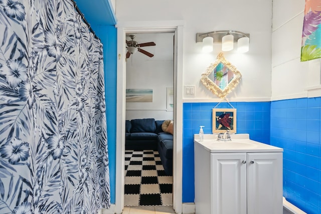 bathroom featuring vanity, ceiling fan, and tile walls