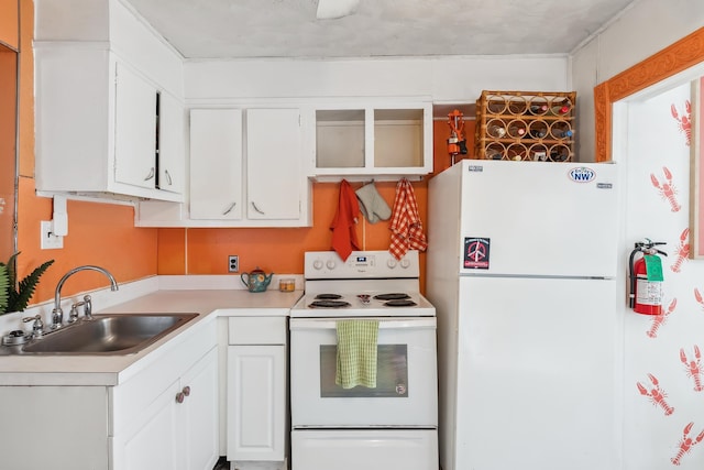 kitchen with white cabinetry, white appliances, and sink