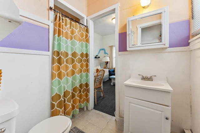 bathroom with tile patterned floors, vanity, and toilet