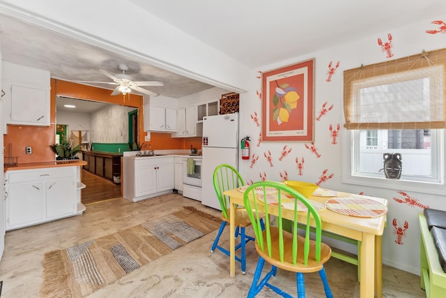 dining room featuring ceiling fan and sink