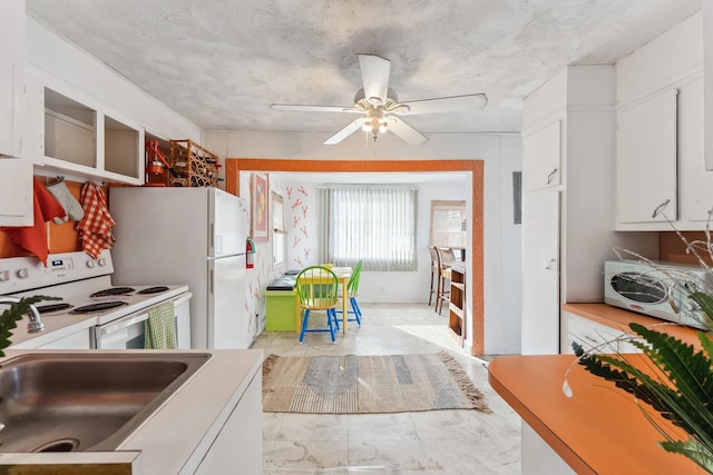 kitchen featuring white cabinets, white appliances, ceiling fan, and sink