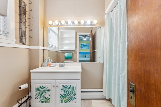 bathroom featuring tile patterned flooring, vanity, and curtained shower