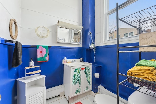 bathroom featuring tile patterned flooring, vanity, and toilet