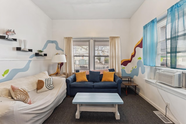 living room featuring dark colored carpet, cooling unit, and a healthy amount of sunlight