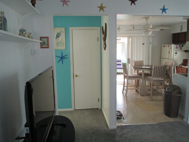 interior space with ceiling fan and carpet floors