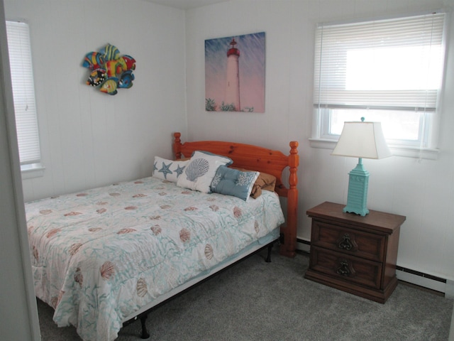 bedroom with baseboard heating and carpet