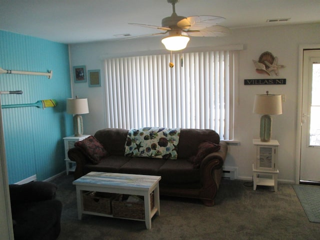 living room featuring ceiling fan, a baseboard radiator, and dark colored carpet