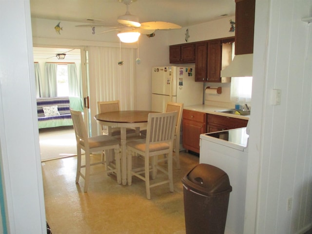 kitchen with white refrigerator, ceiling fan, and sink