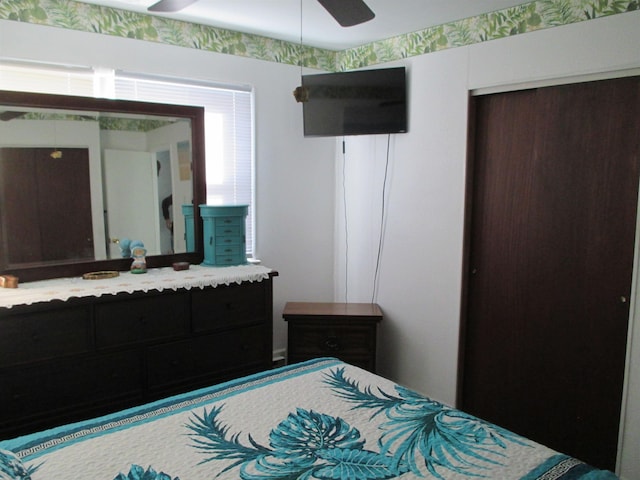 bedroom with ceiling fan and a closet